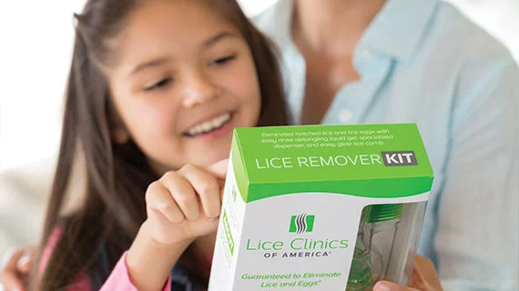 Mom and daughter reading the box of the Lice Remover Kit
