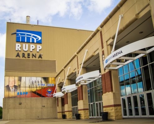 Side view of the front entrance of Rupp Arena sunny sky with clouds in background