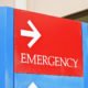 sign at the hospital points towards the emergency room entrance.